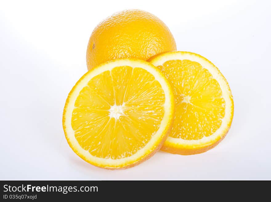 Ripe orange and two slices on white background. Ripe orange and two slices on white background