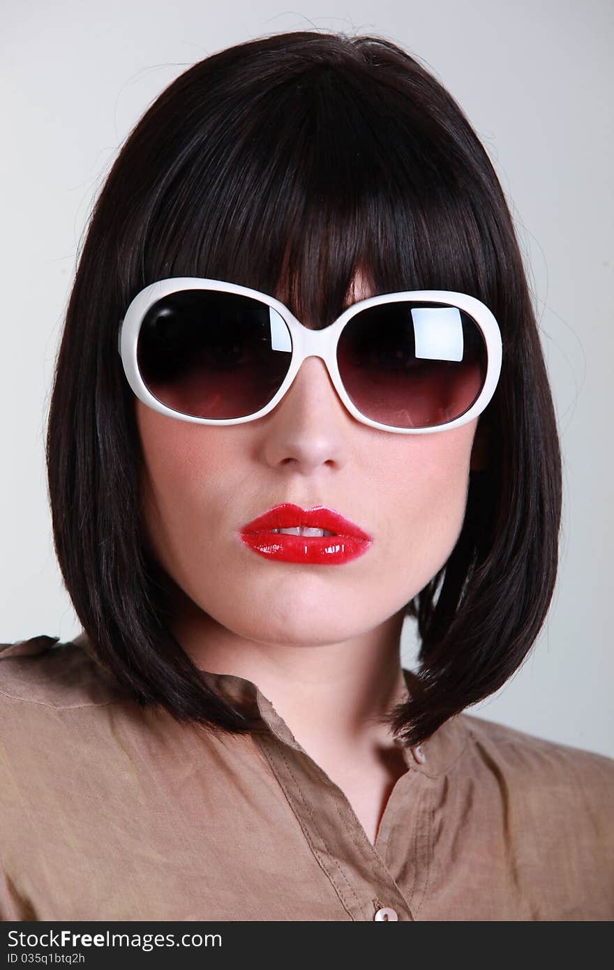 Young woman wearing sunglasses on white background. Young woman wearing sunglasses on white background