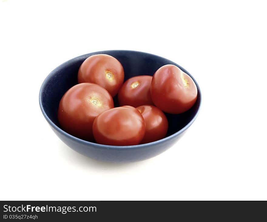 Red tomatoes in a blue bowl