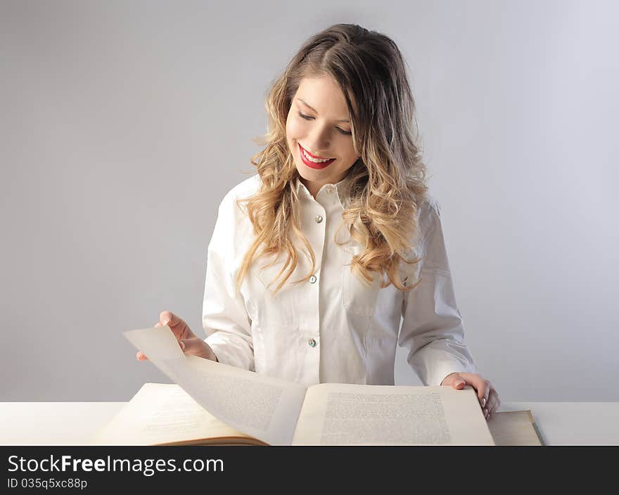 Smiling beautiful woman reading a book. Smiling beautiful woman reading a book