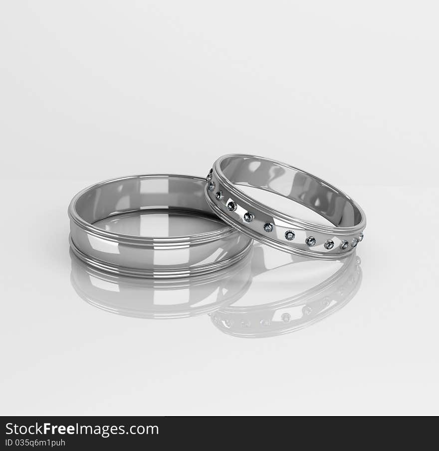 Wedding rings with brilliants on a white background