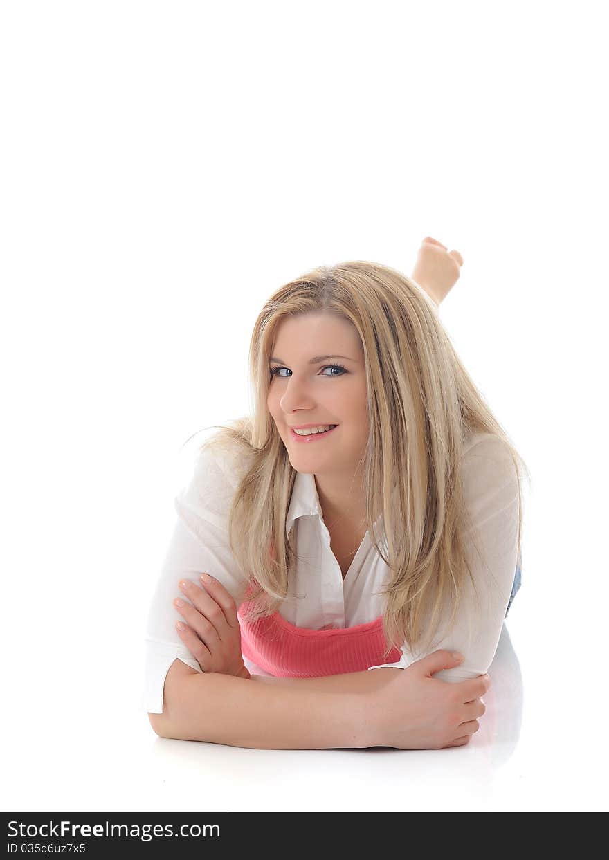 Young casual smiling woman lying on the floor isolated on white background