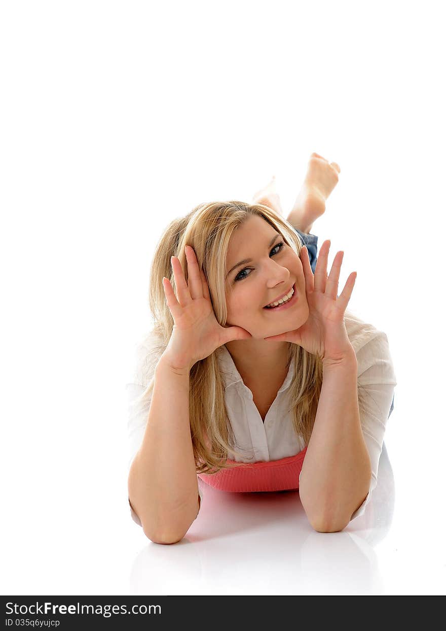 Young casual smiling woman lying on the floor isolated on white background