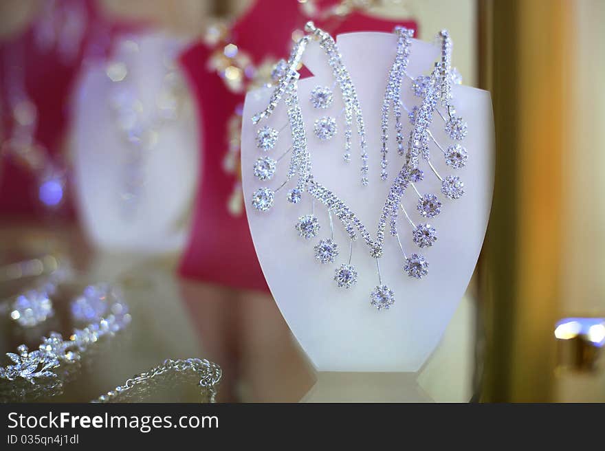 Shiny earrings and necklace at the shopwindow