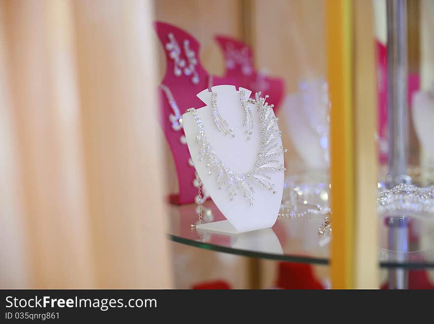 Necklace and earrings on fixture at the shop shelf