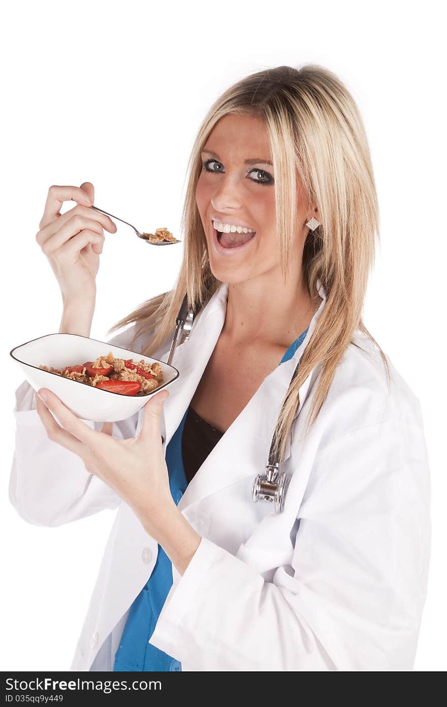 A woman doctor is eating a bowl of cereal. A woman doctor is eating a bowl of cereal.