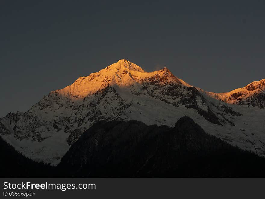 Sunshine makes Meili mountain looks golden. It is in Yun Nan province China. Sunshine makes Meili mountain looks golden. It is in Yun Nan province China.