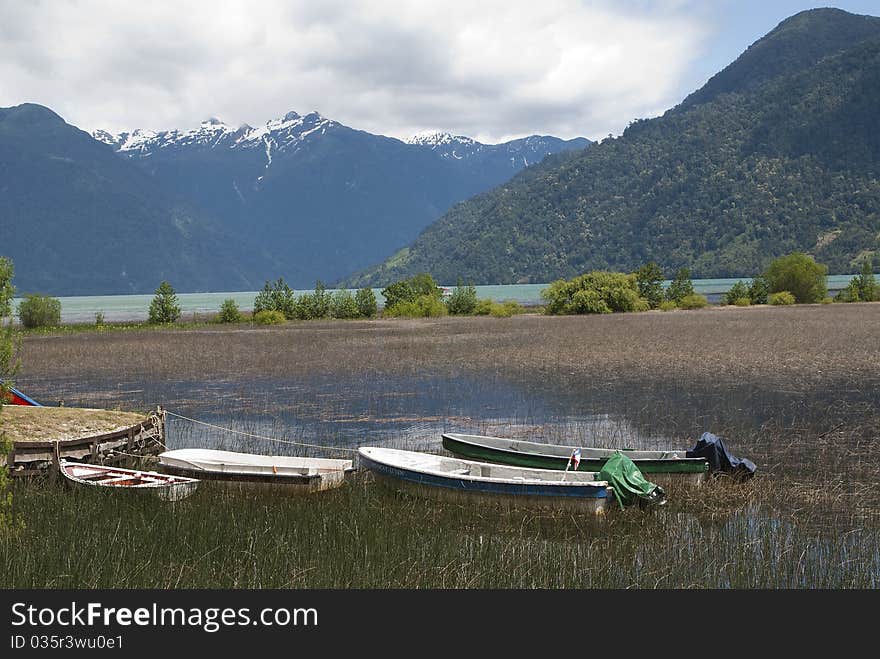 Boats resting on the shore of a lake. Boats resting on the shore of a lake