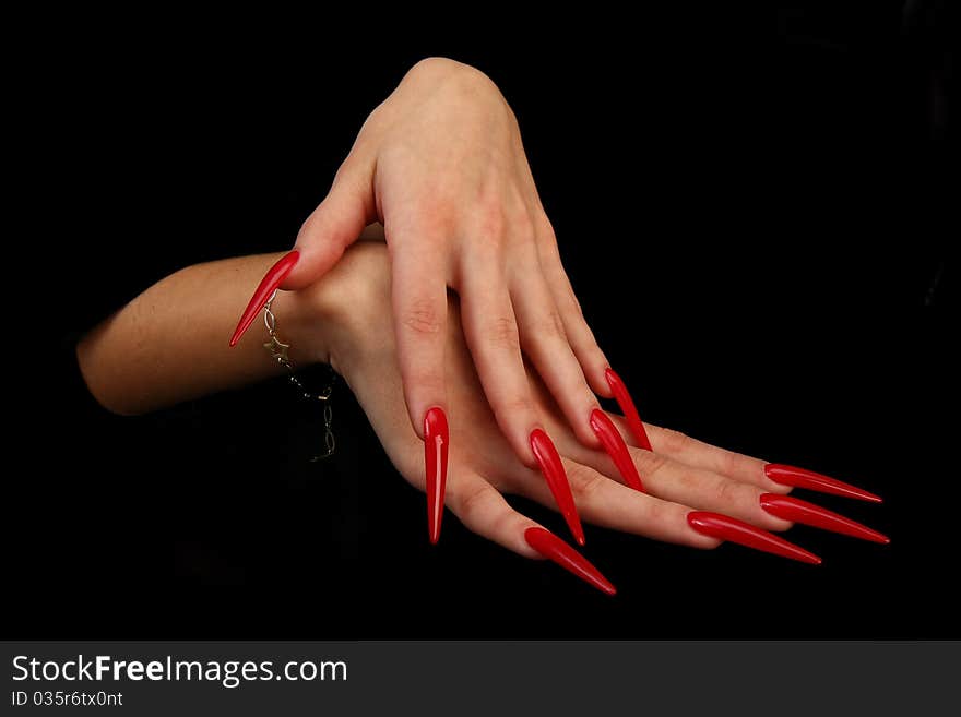 Human fingers with long fingernail and beautiful manicure isolated on black