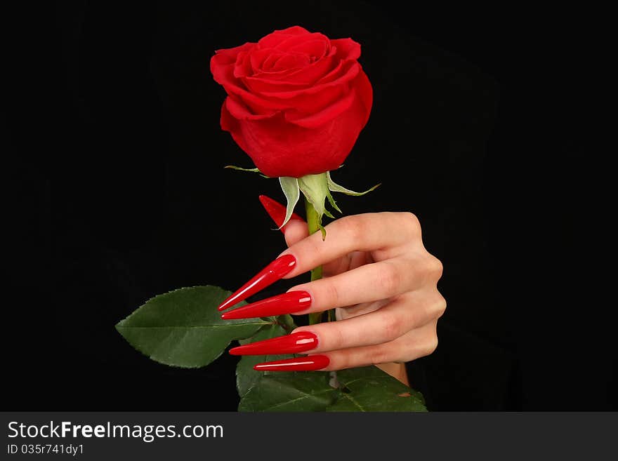 Human fingers with long fingernail and beautiful manicure isolated on black