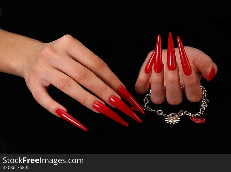 Human fingers with long fingernail and beautiful manicure isolated on black