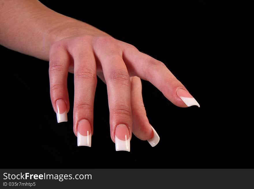 Human fingers with long fingernail and beautiful manicure isolated on black