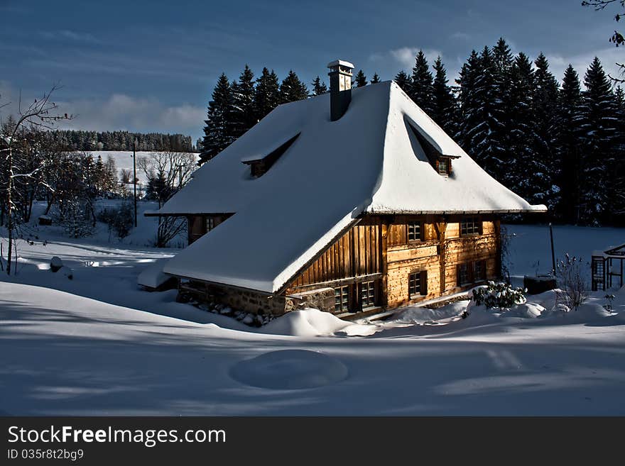 Block house in a winter landscape