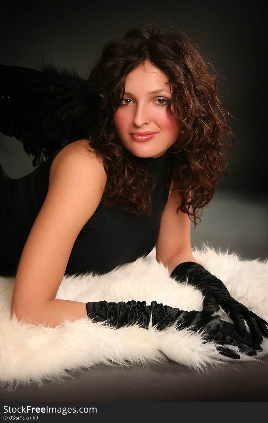 Beautiful young angel with black wings. Beautiful young angel with black wings