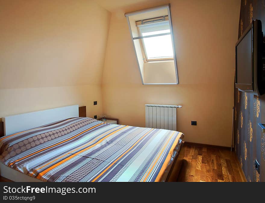 Interior of a bedroom, with modern furniture and light equipment.