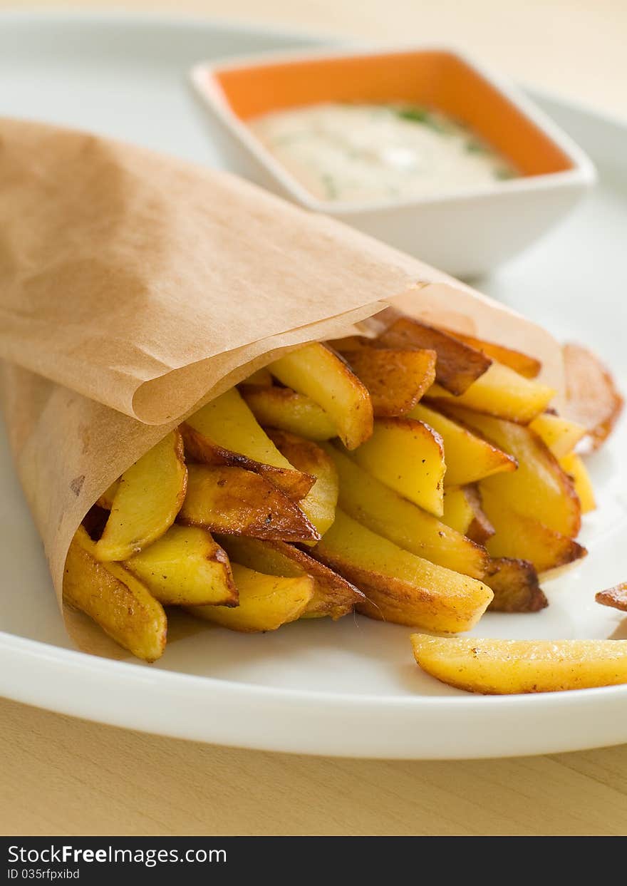 Fried potatoes with sauce on plate