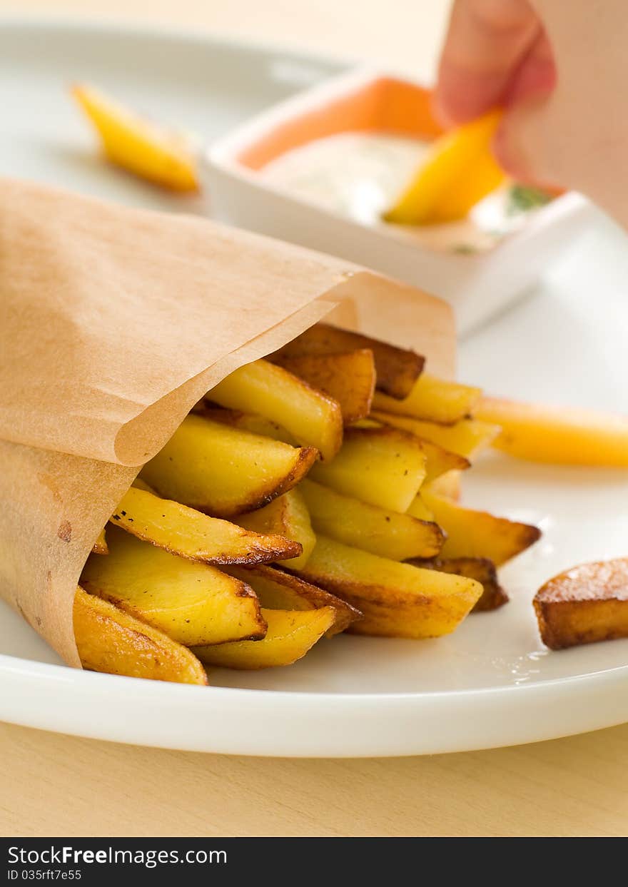 Fried potatoes with sauce on plate