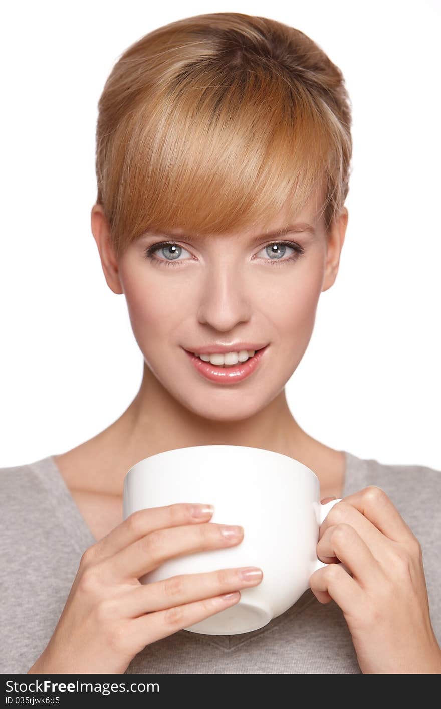 Portrait of a beautiful woman, drinking tea or coffee, isolated on white