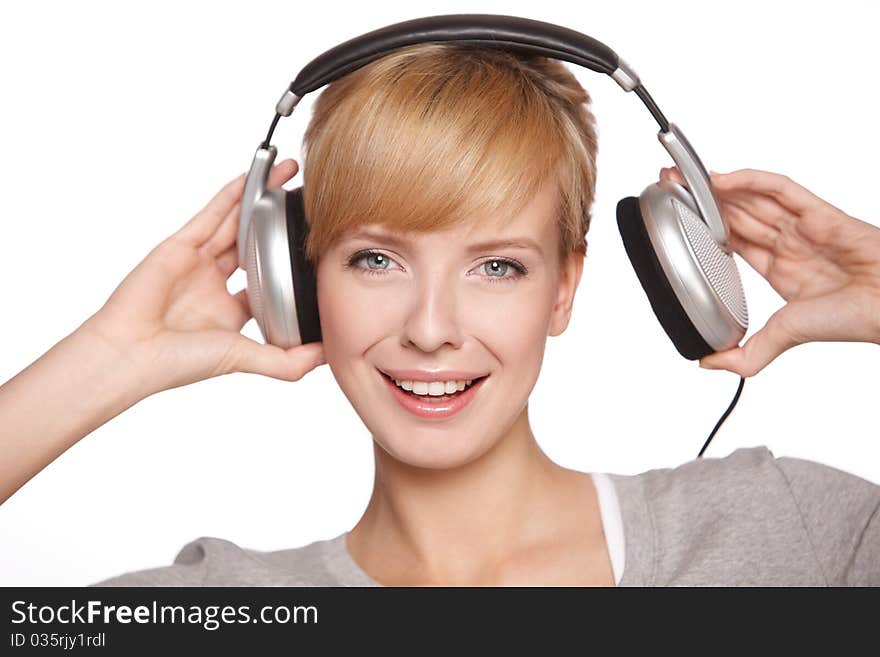 Closeup of a pretty blond female listening to music over headphones. Closeup of a pretty blond female listening to music over headphones