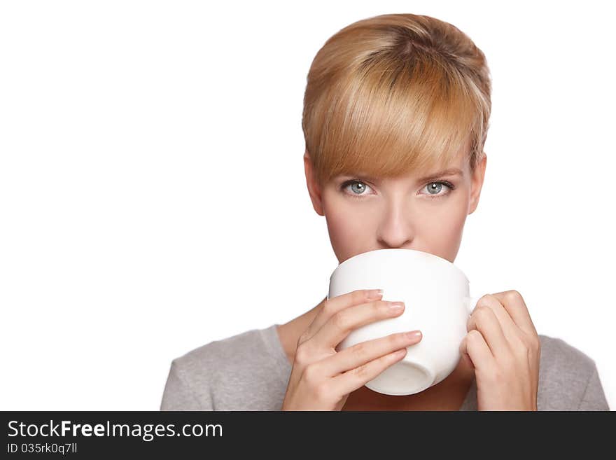 Portrait of a beautiful woman, drinking tea or coffee, isolated on white