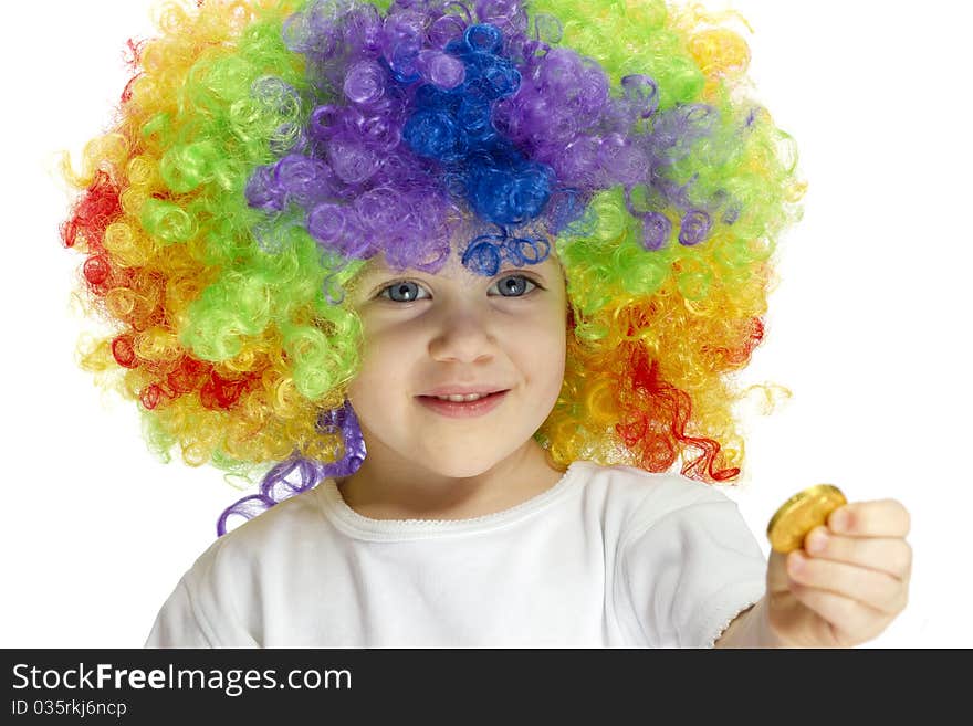 Curly haired girl shows a coin in a studio scene