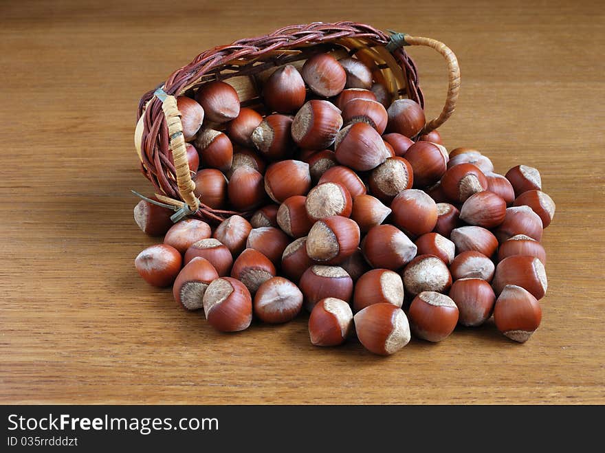 Small group of dry wood nuts on a wooden table. Small group of dry wood nuts on a wooden table