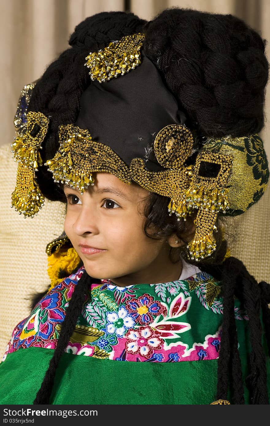 Adorable little princess wearing feathered crown.