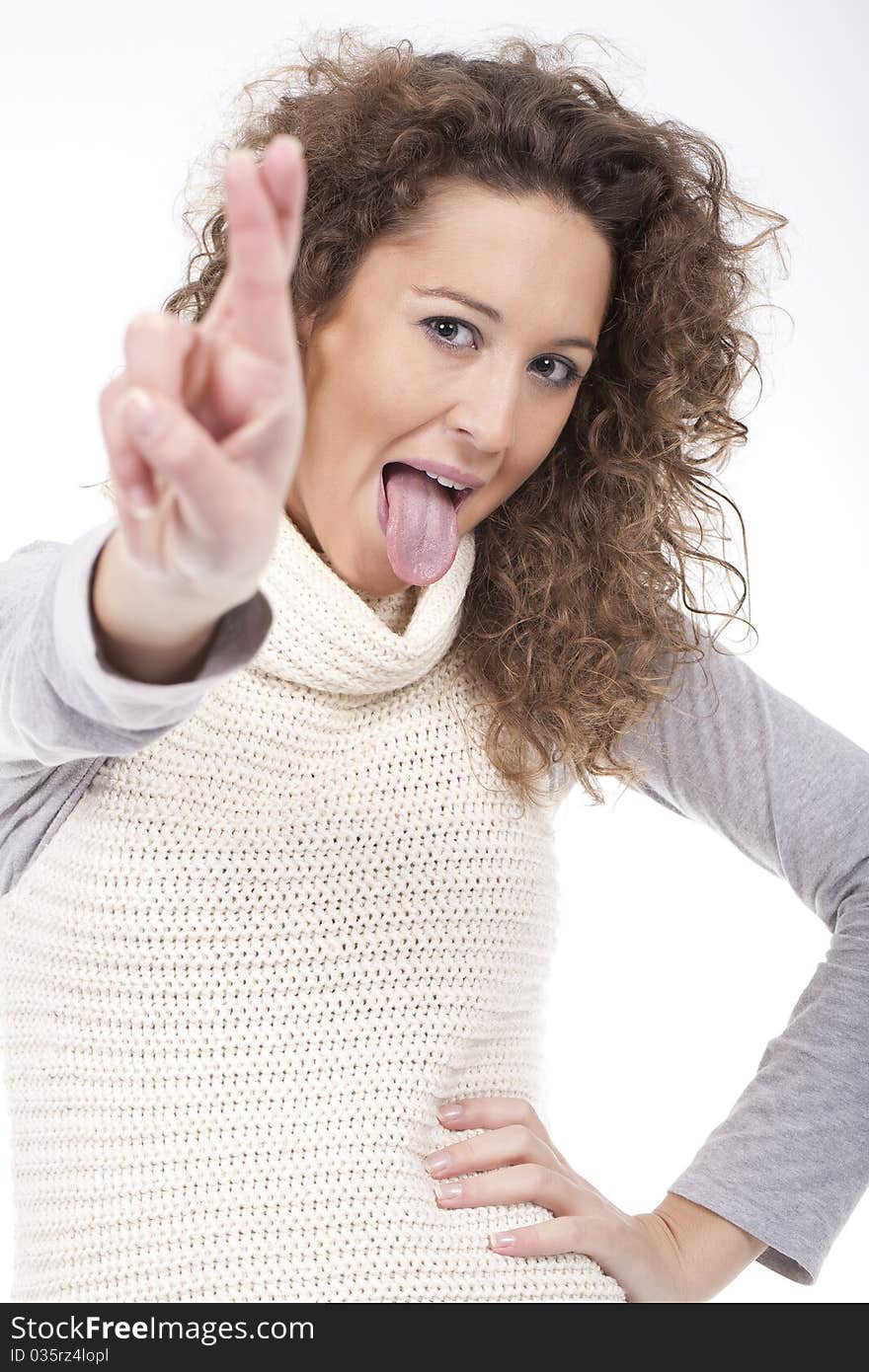 Woman making a crazy face with tong out and crossing fingers. Woman making a crazy face with tong out and crossing fingers