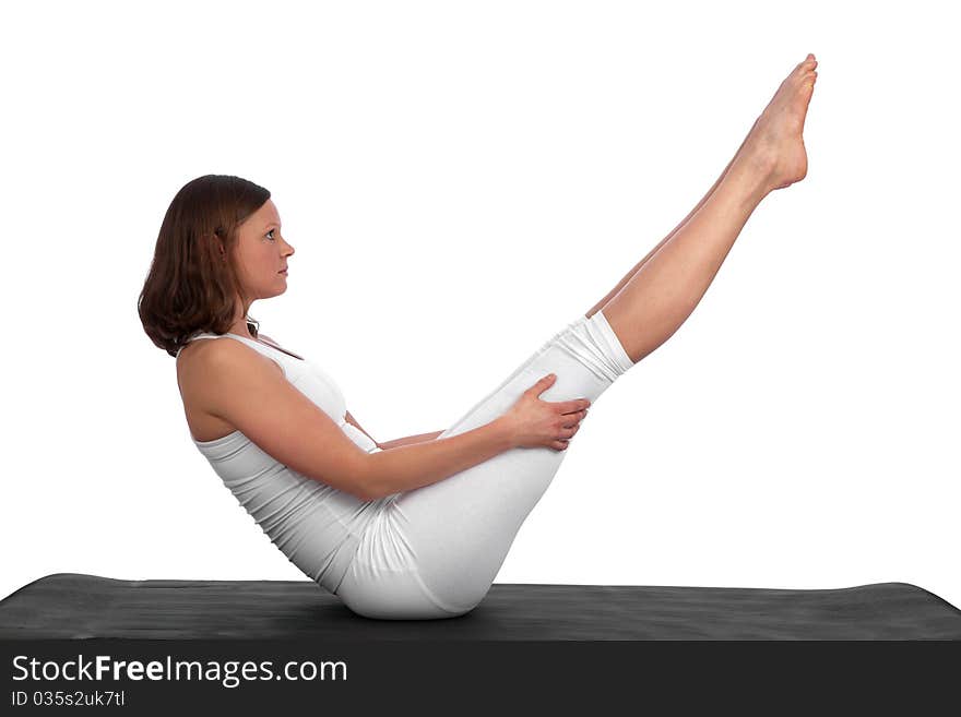 Fit and muscular young caucasian woman doing a V-shape with her body on a yoga mat. Fit and muscular young caucasian woman doing a V-shape with her body on a yoga mat