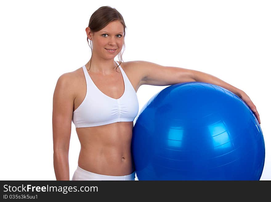 Fit and muscular young caucasian woman posing with blue exercise ball. Fit and muscular young caucasian woman posing with blue exercise ball