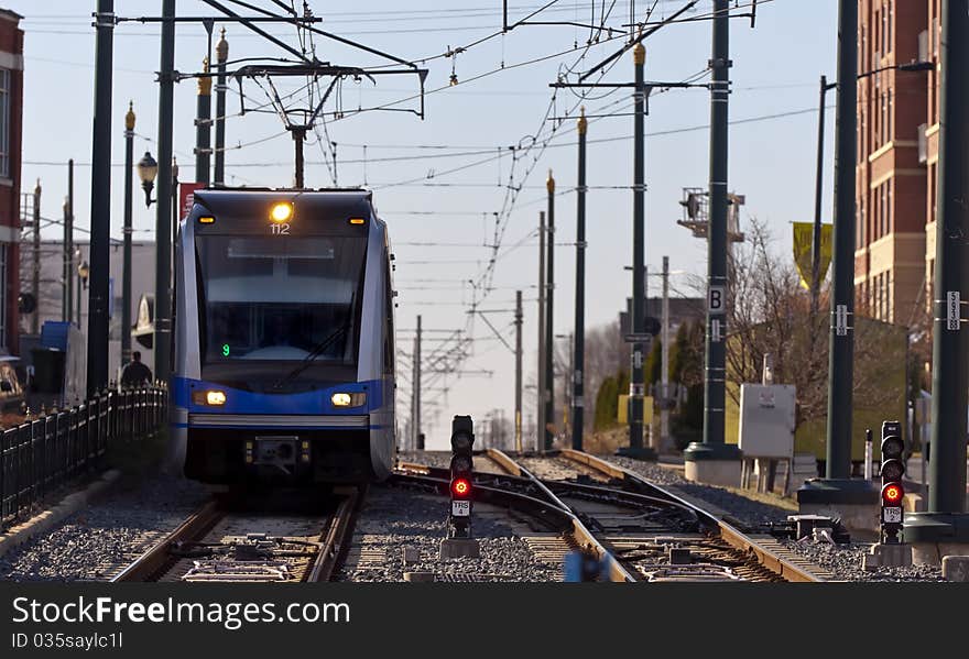 A light rail train system in a city environment. A light rail train system in a city environment