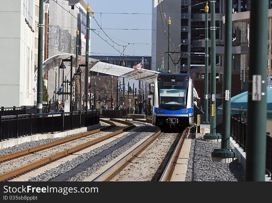 A light rail train system in a city environment. A light rail train system in a city environment