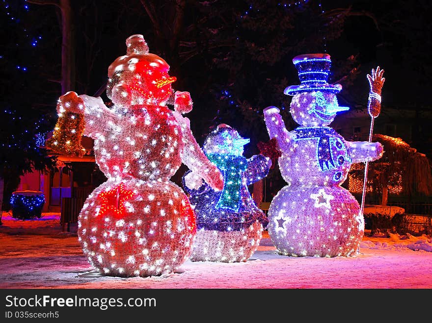 Three snowmen with holiday lights