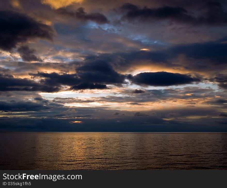 Sunrise over sea with dark sky. Sunrise over sea with dark sky.