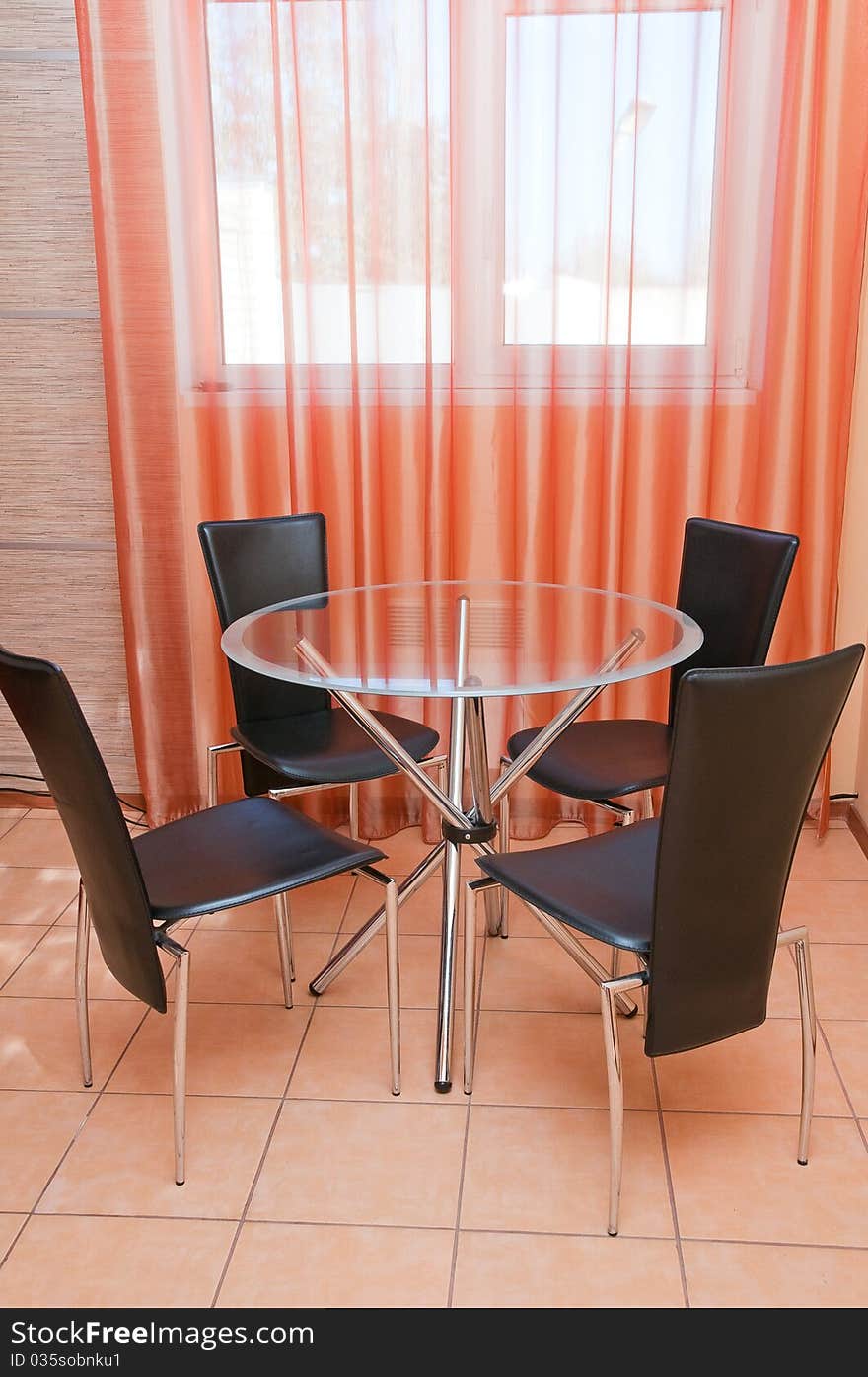 Round glass table in a kitchen interior.