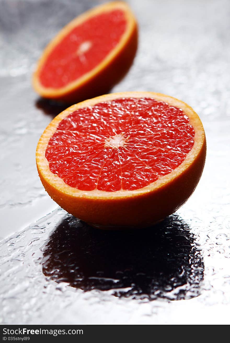 Fresh and wet grapefruit with reflection. Fresh and wet grapefruit with reflection