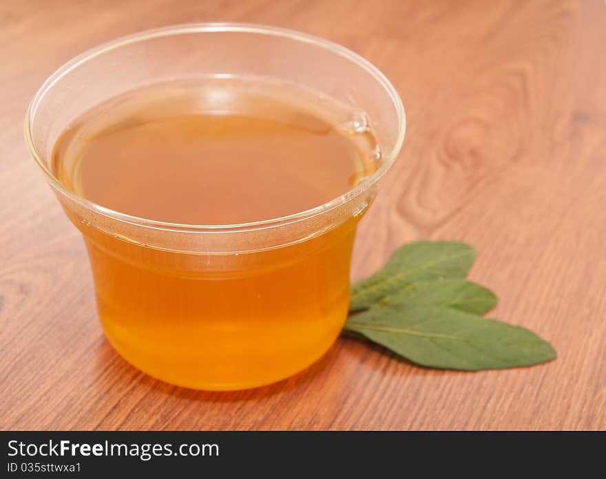 Cup of green tea on wooden table