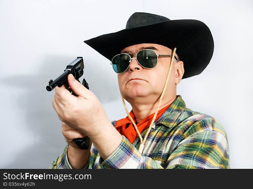 One man in cowboy dress and hat. Shooting in the studio. One man in cowboy dress and hat. Shooting in the studio.