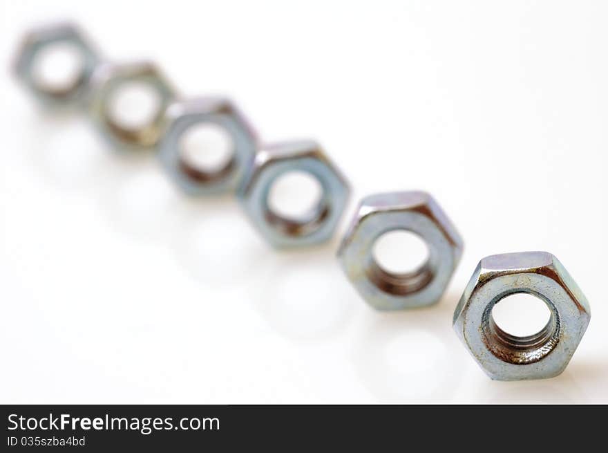 Steel nuts on a white background