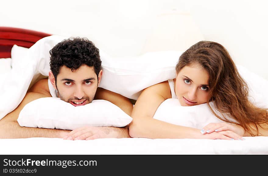 Young and beautiful couple in bed. Young and beautiful couple in bed