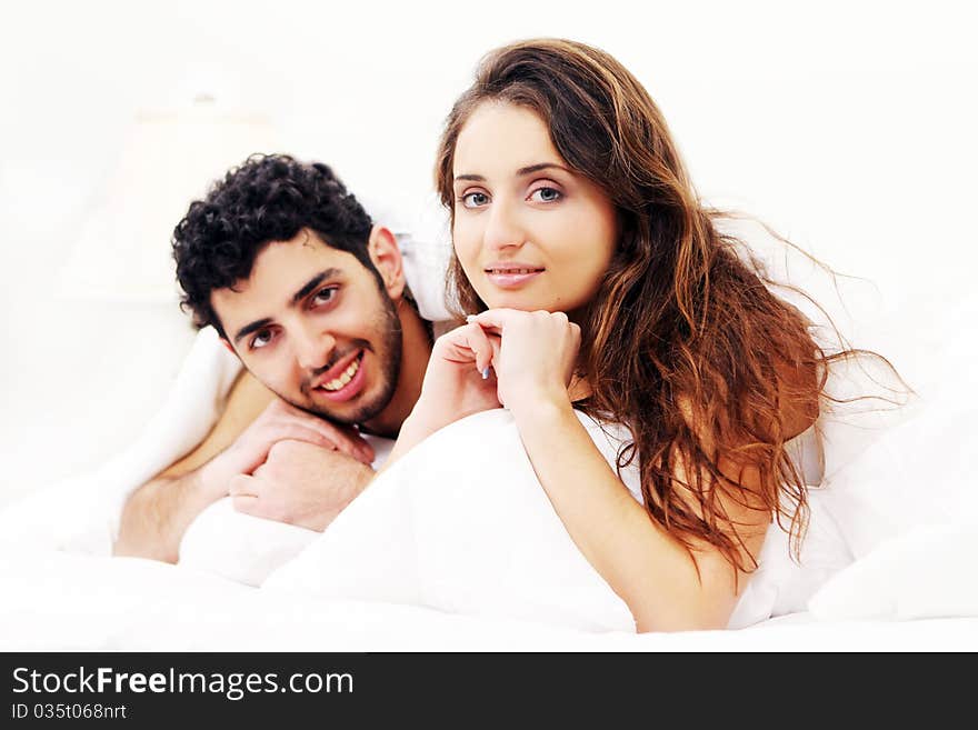 Young and beautiful couple in bed. Young and beautiful couple in bed