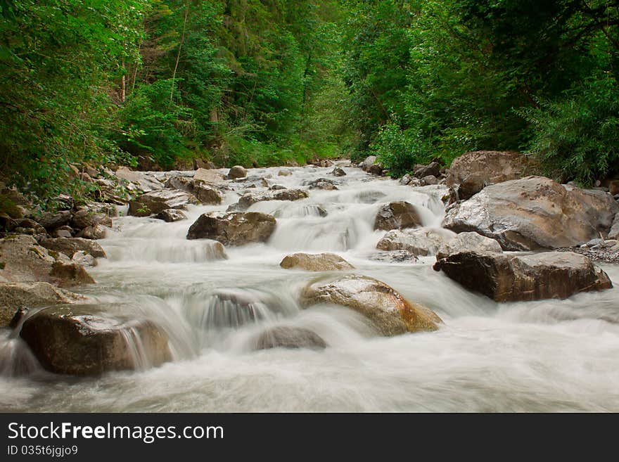 View on waterfall cascade in green forest