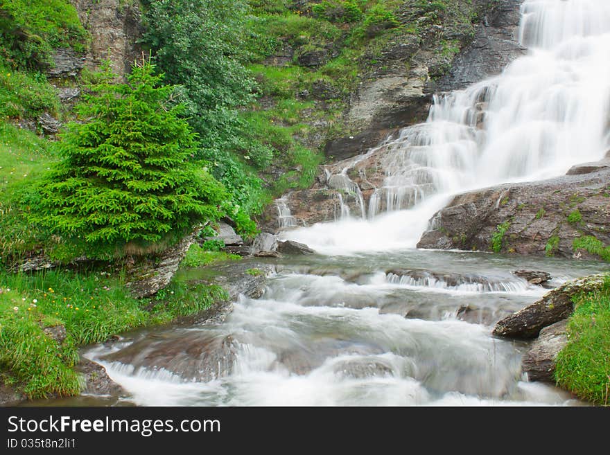 Waterfall in green alps mountains, near Grindelwald. Waterfall in green alps mountains, near Grindelwald