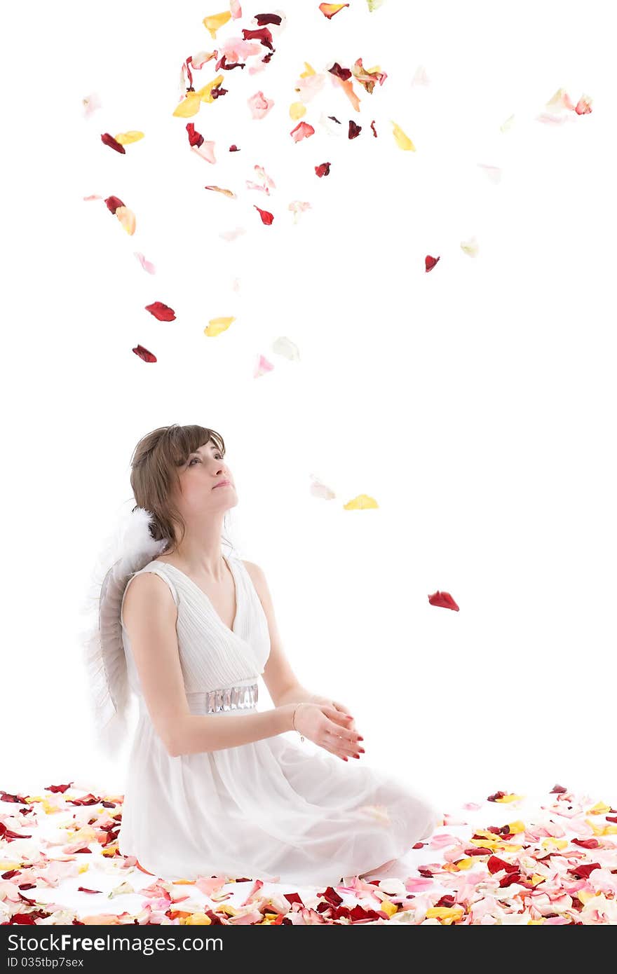 Girl in white dress and wings throwing petals