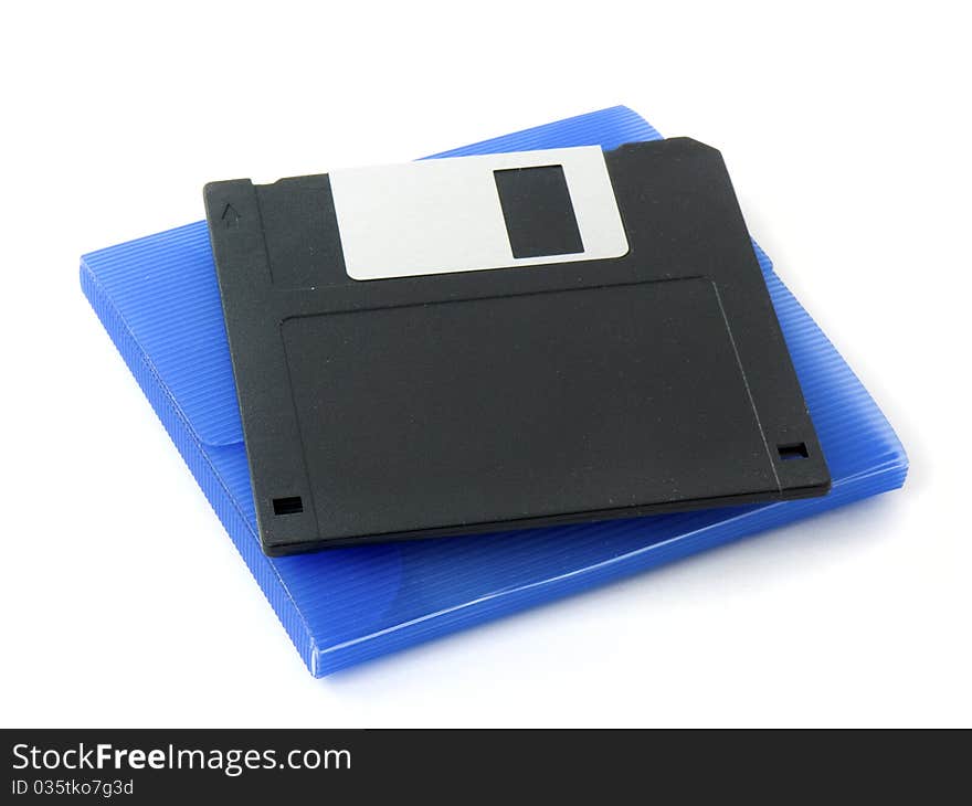 Old floppy disk and a blue atomic disk case isolated on white background. Old floppy disk and a blue atomic disk case isolated on white background