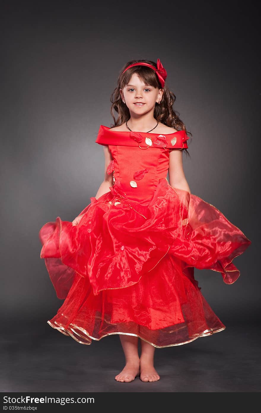 Beautiful little princess dancing in luxury dress