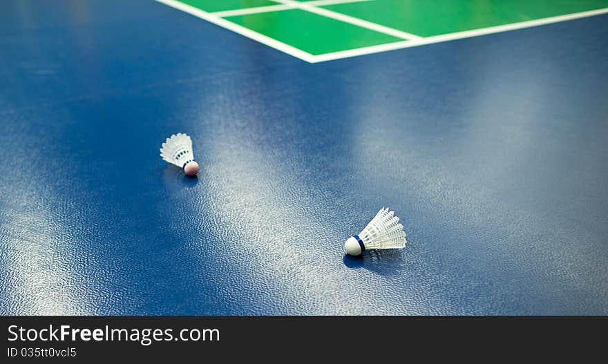 Badminton - badminton courts with shuttlecocks in the foreground (shallow DOF; color toned image). Badminton - badminton courts with shuttlecocks in the foreground (shallow DOF; color toned image)