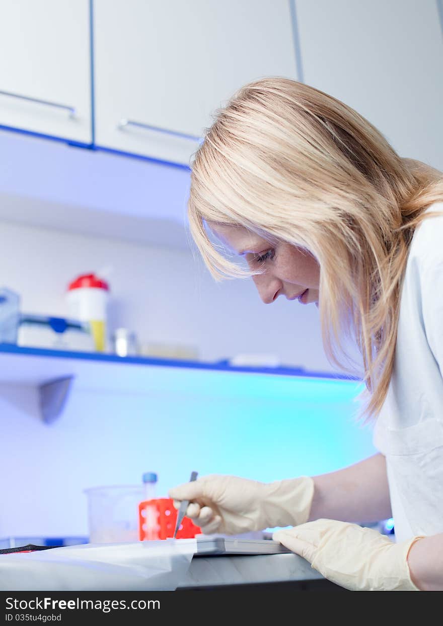 Portrait of a female researcher doing research in a lab (color toned image; shallow DOF)