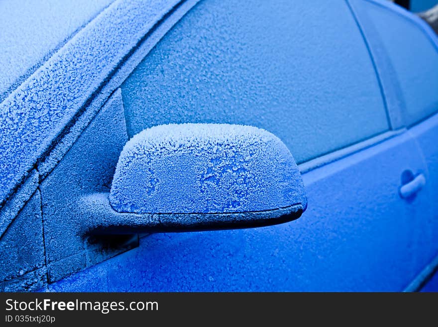 Ice on a blue car during winter season, good for concepts. Ice on a blue car during winter season, good for concepts