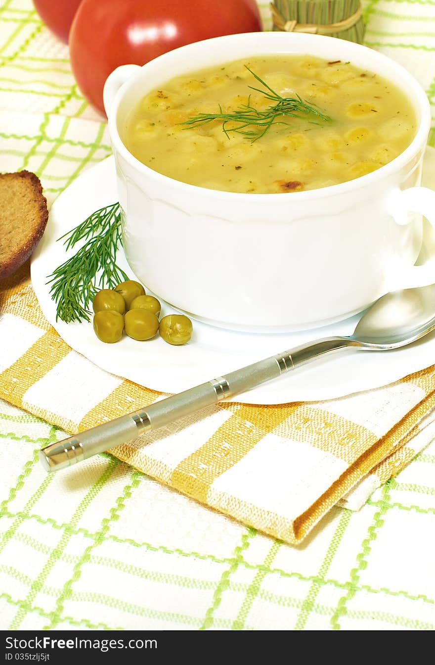 Bowl of homemade pea soup with brown bread